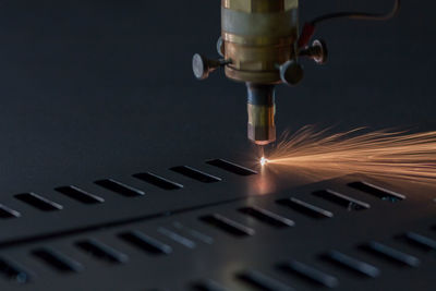 Close-up of illuminated machine in factory