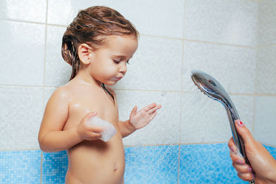 Shirtless boy in bathroom at home