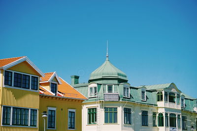 Low angle view of buildings against blue sky