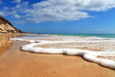 Scenic view of beach against sky