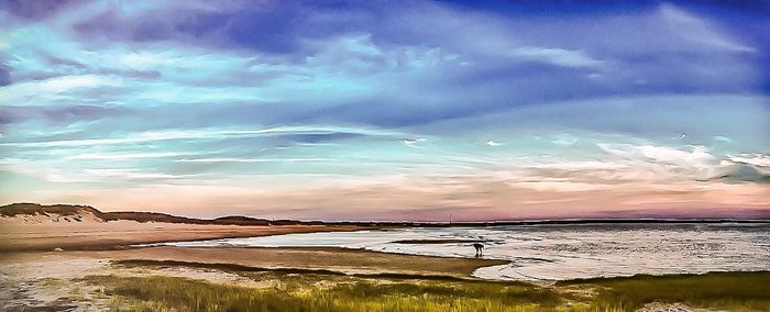 Scenic view of sea against cloudy sky