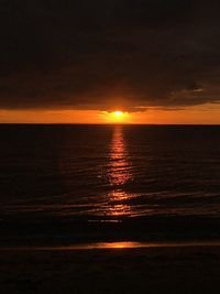 Scenic view of sea against orange sky