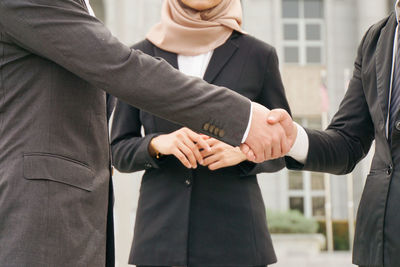 Rear view of a couple holding hands