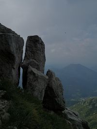 Low angle view of rock formation against sky