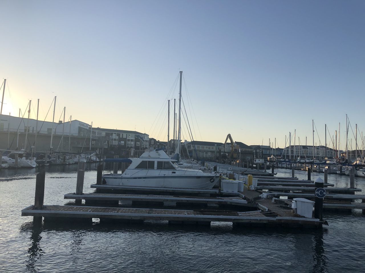 SAILBOATS MOORED IN HARBOR