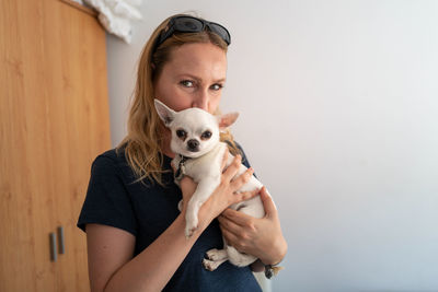 Portrait of man with dog against white background