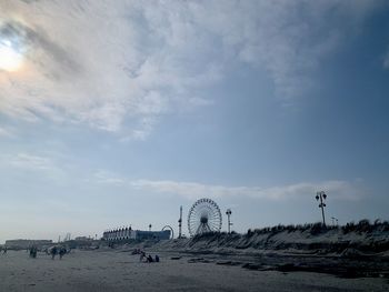 View of beach against cloudy sky