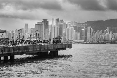 View of city by sea against sky