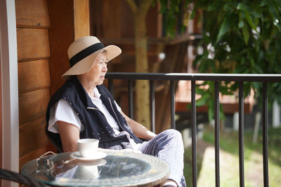 Side view of woman working at workshop