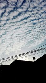 Low angle view of silhouette bridge against sky