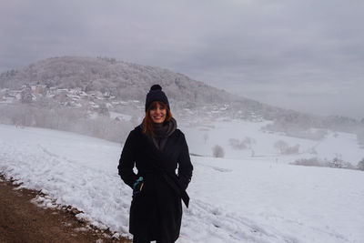 Portrait of woman standing in snow