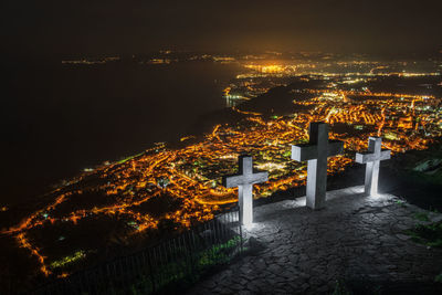 Illuminated buildings against sky at night