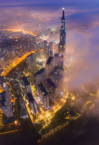 Aerial view of illuminated buildings in city at night