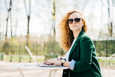 Portrait of young woman using mobile phone