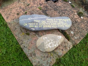 High angle view of text on rock