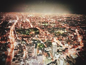 Aerial view of illuminated city buildings at night