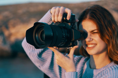 Portrait of woman photographing