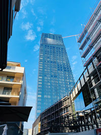 Low angle view of modern buildings against sky in city