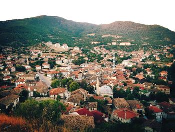 High angle view of townscape by mountains