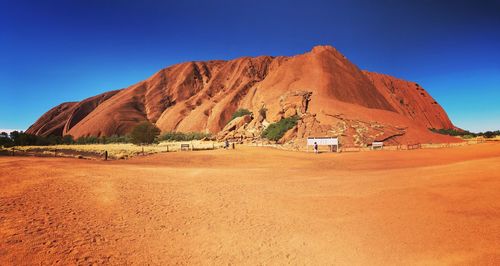 Scenic view of desert against clear blue sky