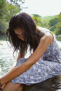 Woman sitting in river 