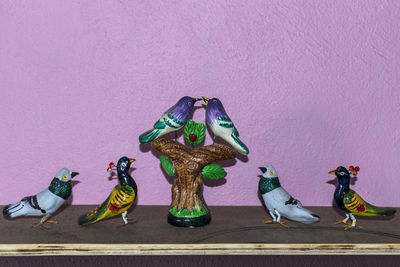 High angle view of toy statue on table against wall