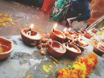 Close-up of burning diyas at temple