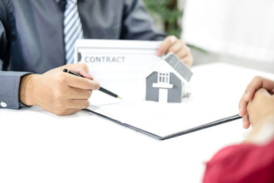 Midsection of business colleagues working at desk in office