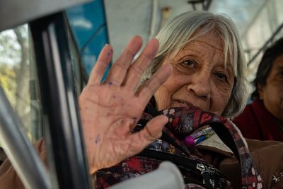 Portrait of old woman in vehicle