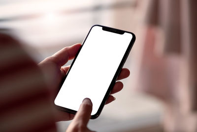 Close-up of hand holding mobile phone