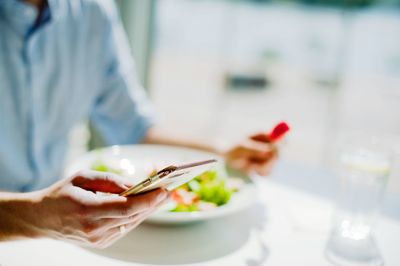 Midsection of woman holding ice cream in plate