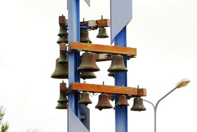 Low angle view of telephone pole against clear blue sky