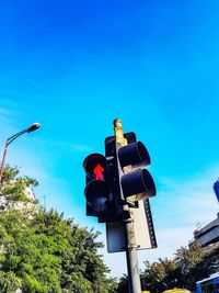Low angle view of tree against blue sky