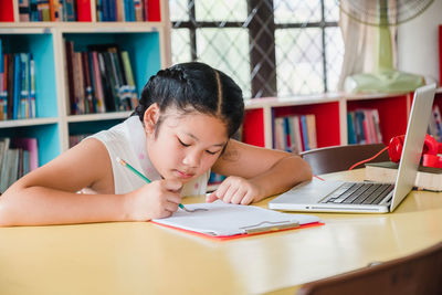 Girl sitting on table
