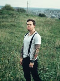 Young man looking away on field