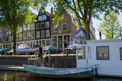 Boats in river with buildings in background