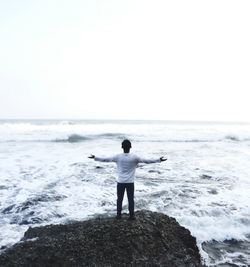 Rear view of man standing on beach