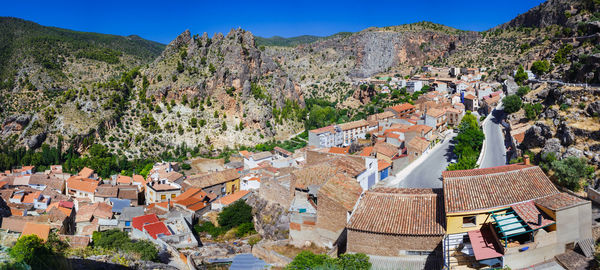 High angle view of houses in town against sky