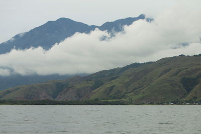 Scenic view of lake and mountains against sky