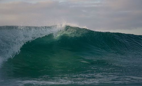 Water splashing in sea against sky