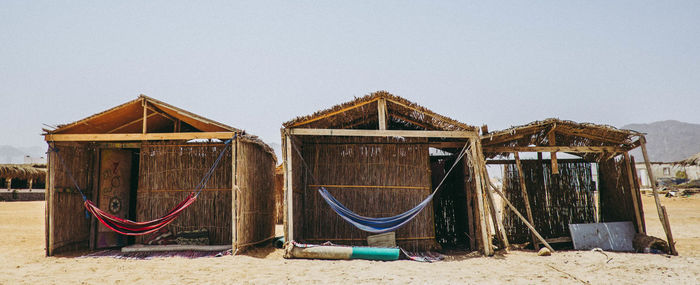 Built structure on beach against clear sky