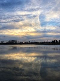 Scenic view of lake against sky during sunset
