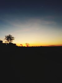 Silhouette landscape against sky during sunset