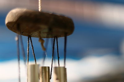 Close-up of hanging against sky