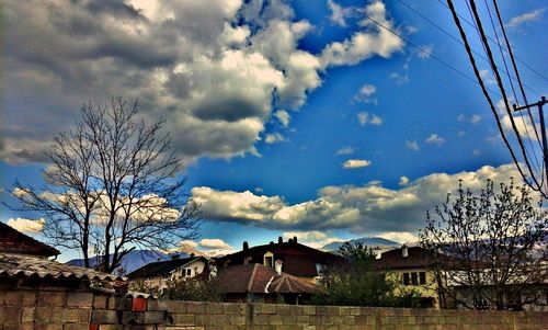 Houses against cloudy sky