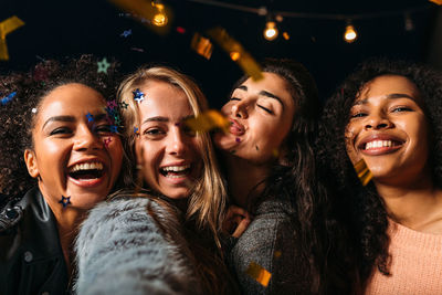 Portrait of smiling friends at night