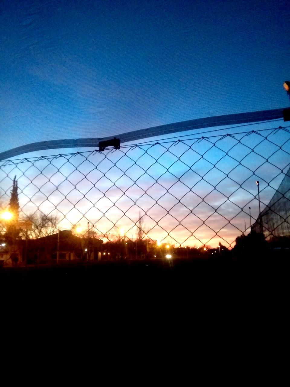 SCENIC VIEW OF SILHOUETTE FENCE AGAINST SKY AT SUNSET