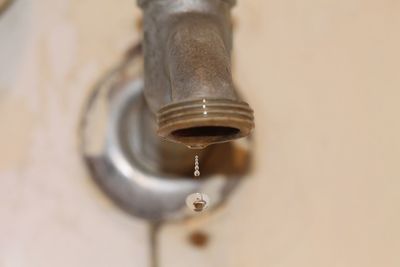 Close-up of water drop from faucet