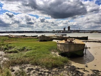 Abandoned building by sea against sky