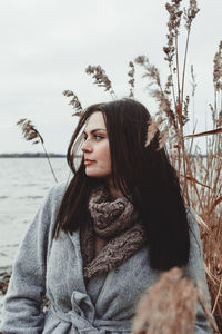 Portrait of young woman looking away in winter